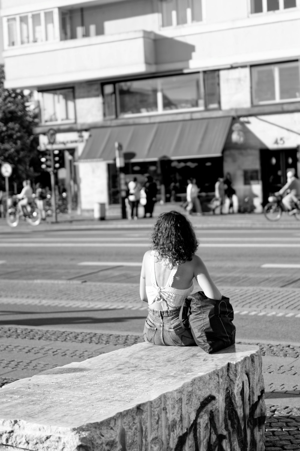 a woman sitting on a stone ledge