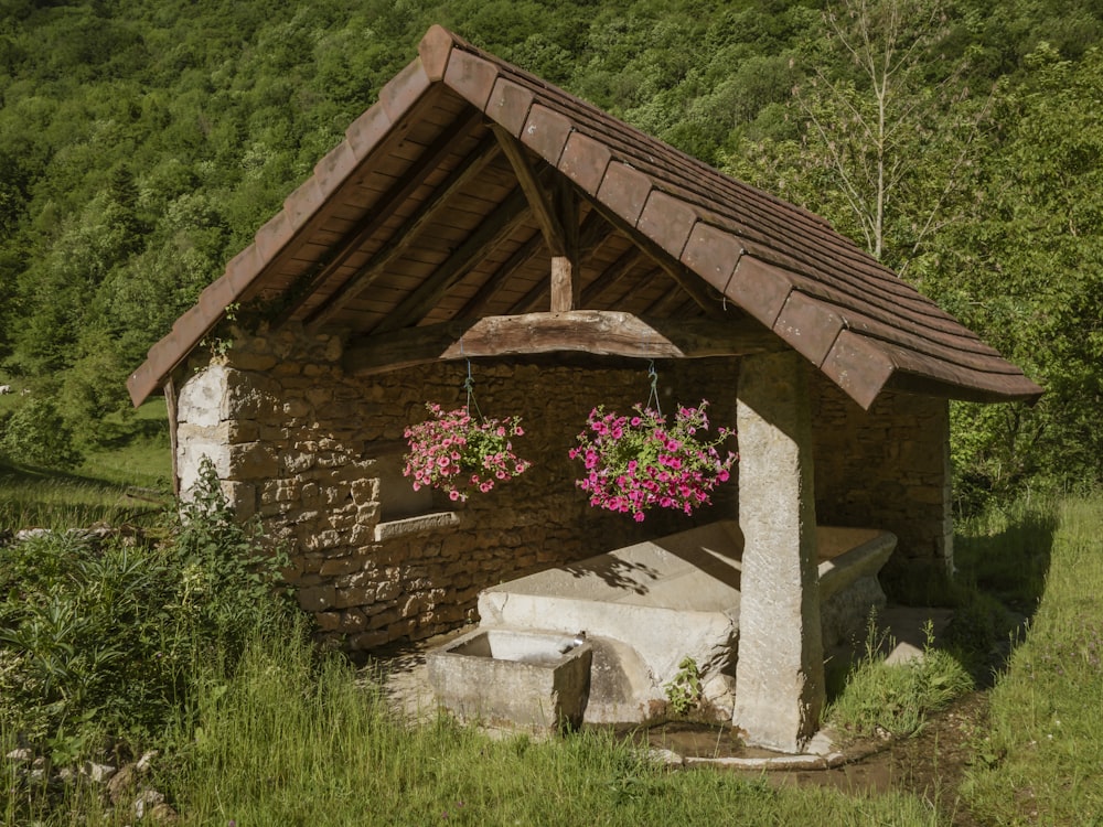 a stone structure with flowers in it