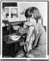 A young girl receiving a nutritious meal at the foundation's dining area.