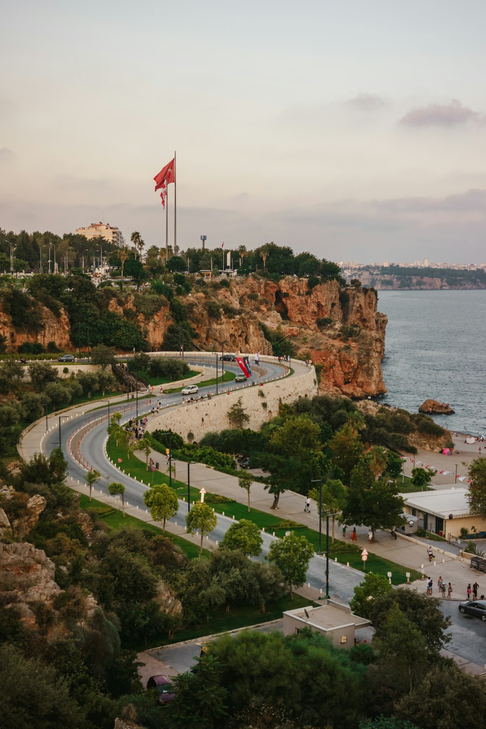 a road with a flag on it by a body of water