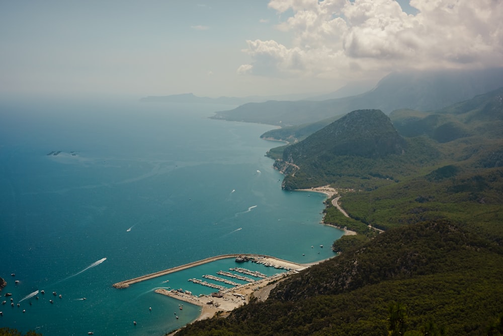 a body of water with land around it and a bridge over it