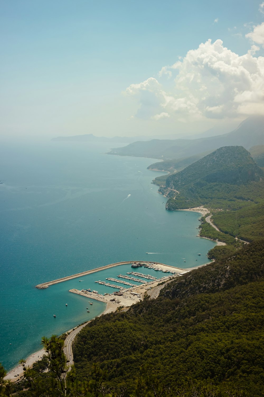 a body of water with land around it and a bridge over it