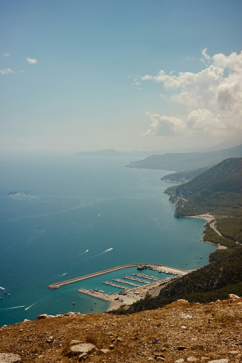 a body of water with a bridge and land around it