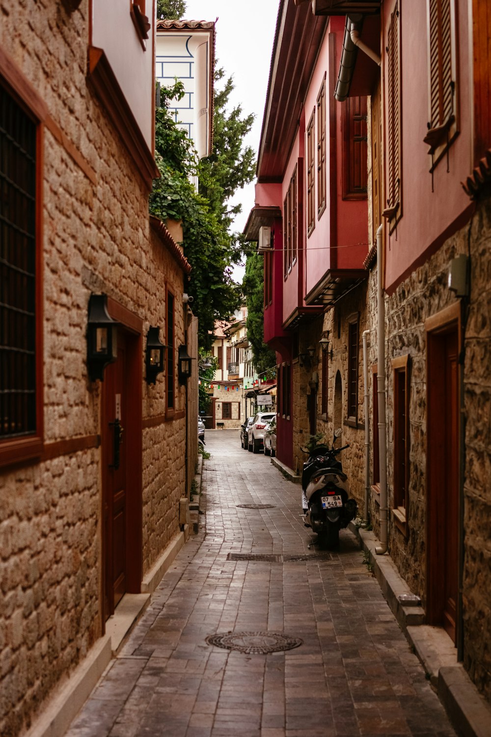 a motorcycle parked on a narrow street