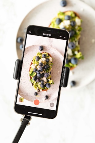 A close-up shot of a smartphone screen displaying the touchstone ai recipe analyzer highlighting ingredients from a photographed recipe card.