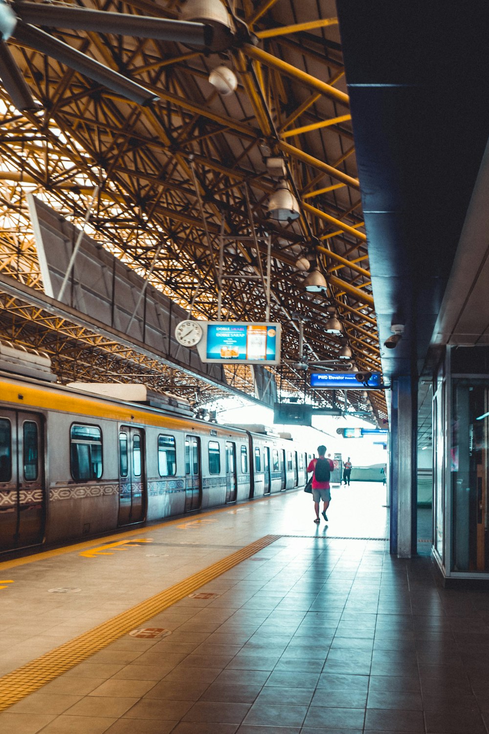 a train station with a person walking