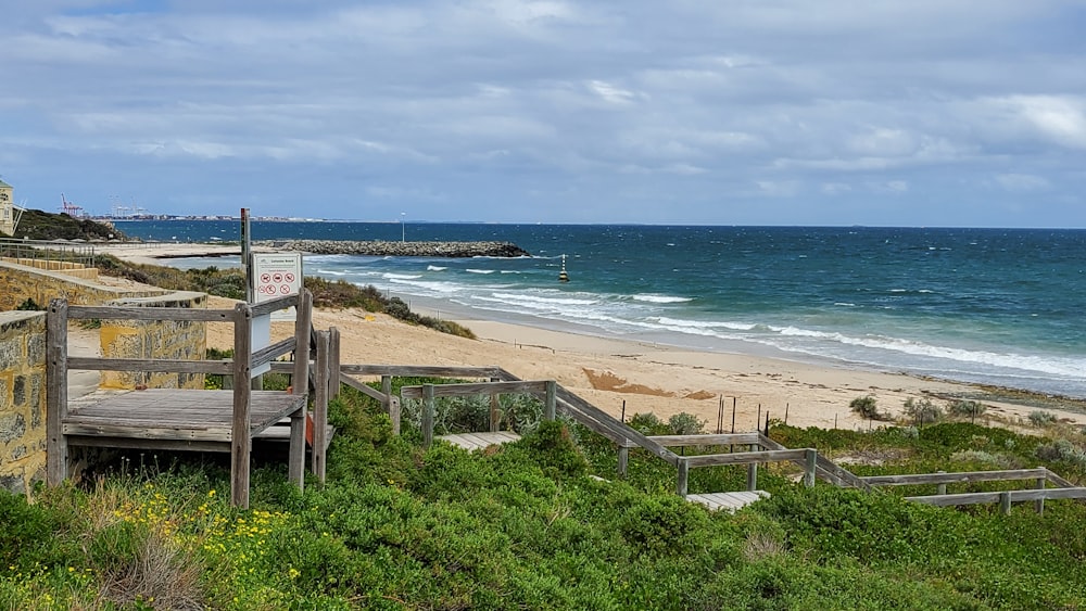 a beach with a wooden fence