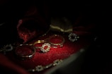 A close-up of elegant silver rings displayed on a soft velvet surface.