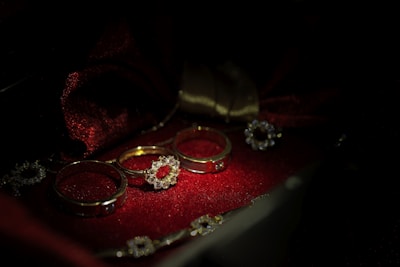 A close-up of elegant gold and silver rings and necklaces displayed on velvet