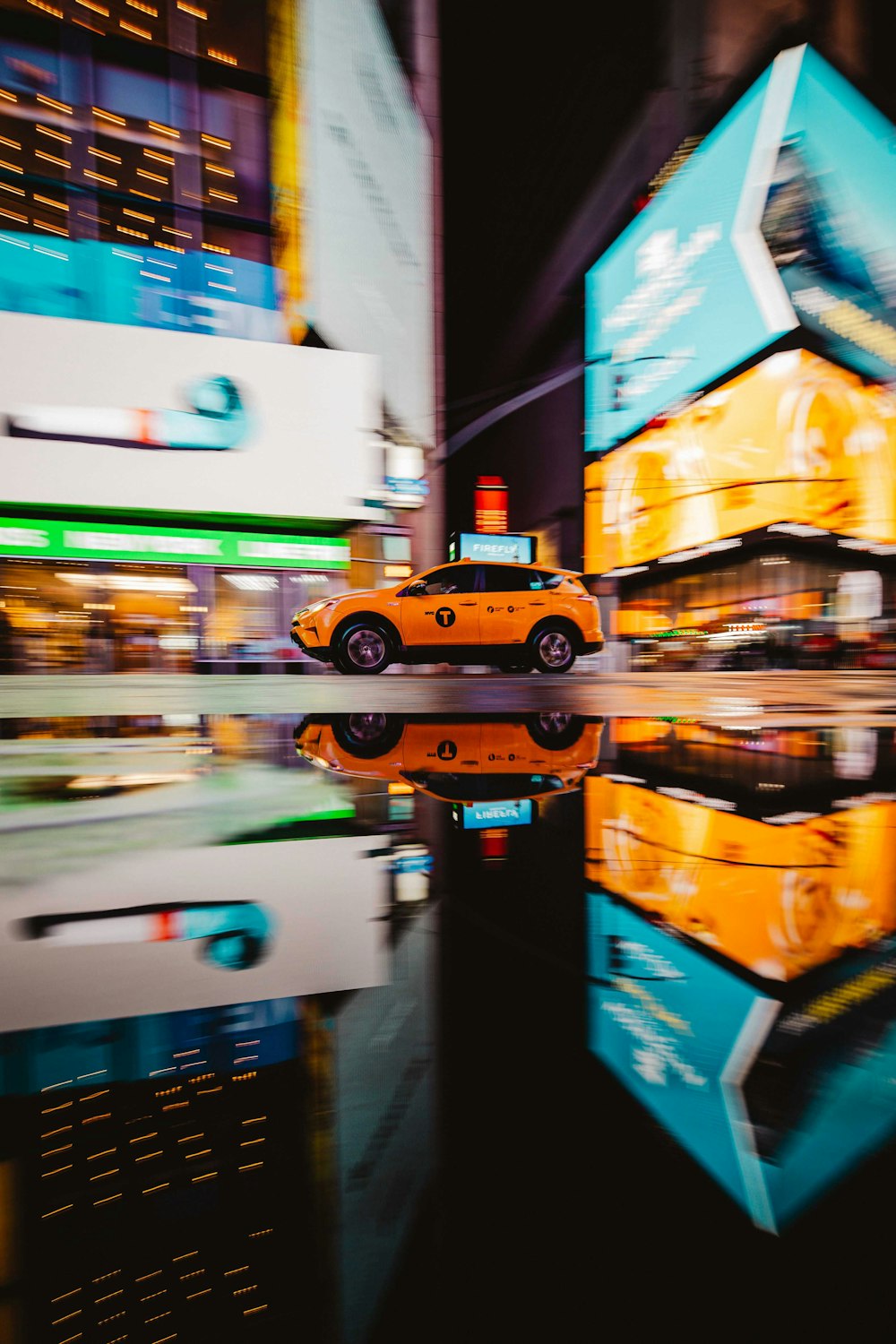 a yellow car driving through a city