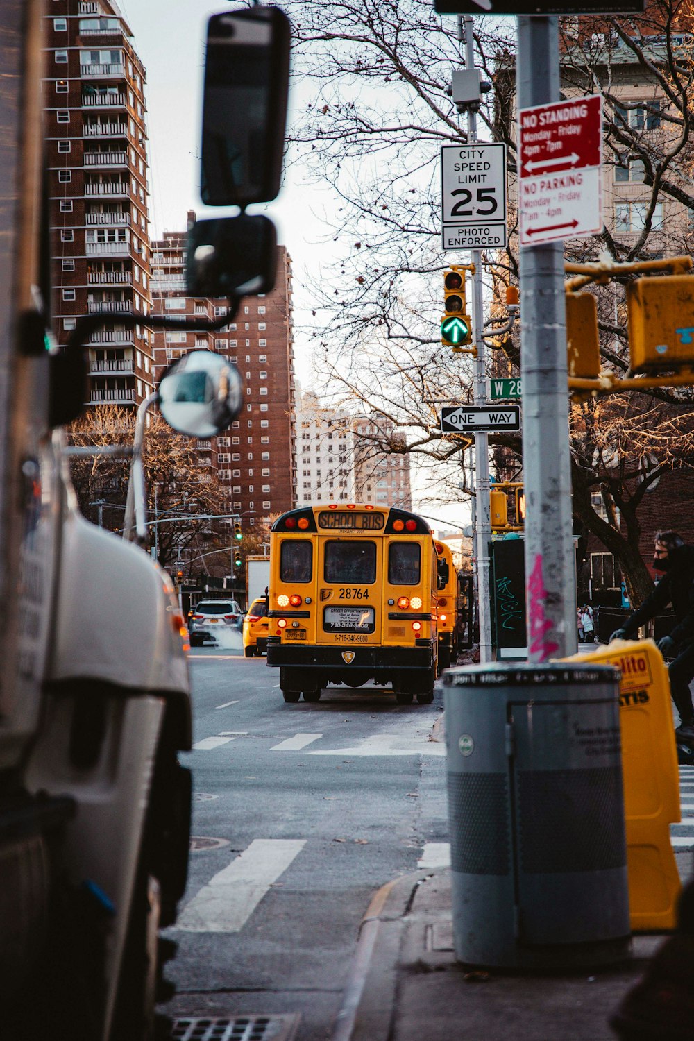 a yellow bus going down the street