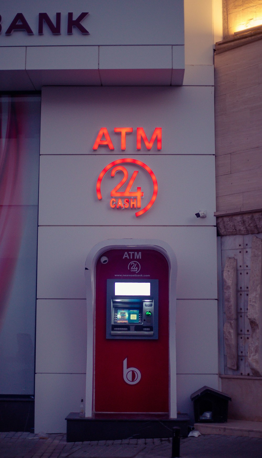 a red and white atm machine