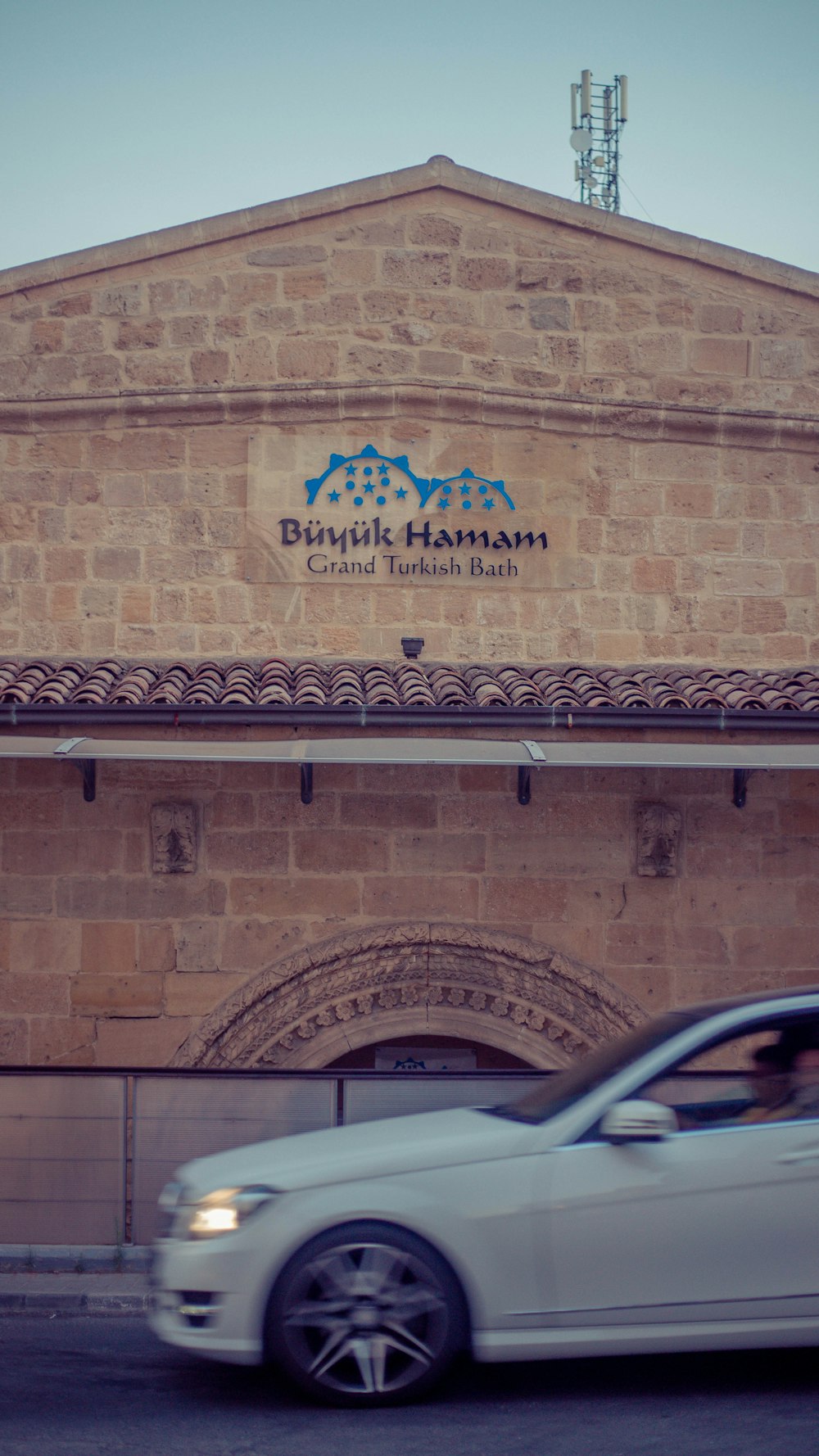 a car parked in front of a brick building