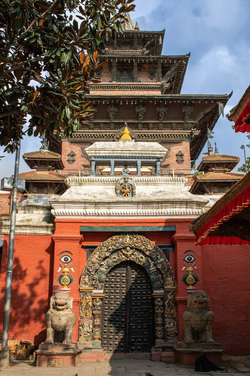 a building with a large door and statues in front of it