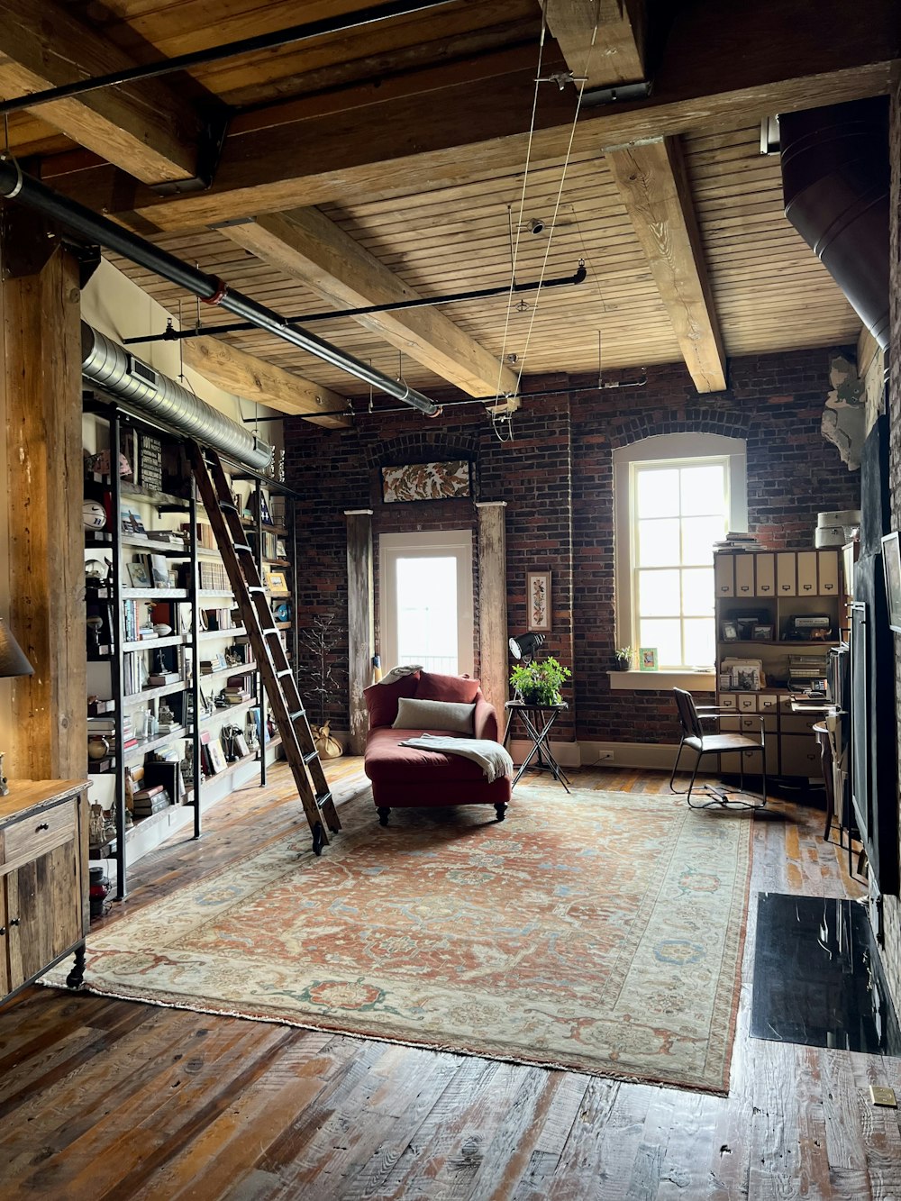 a room with a ladder and bookshelves