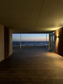 A peaceful moment captured on a quiet deck, with gentle waves and a pastel sky.
