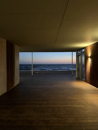 A peaceful moment captured on a quiet deck, with gentle waves and a pastel sky.