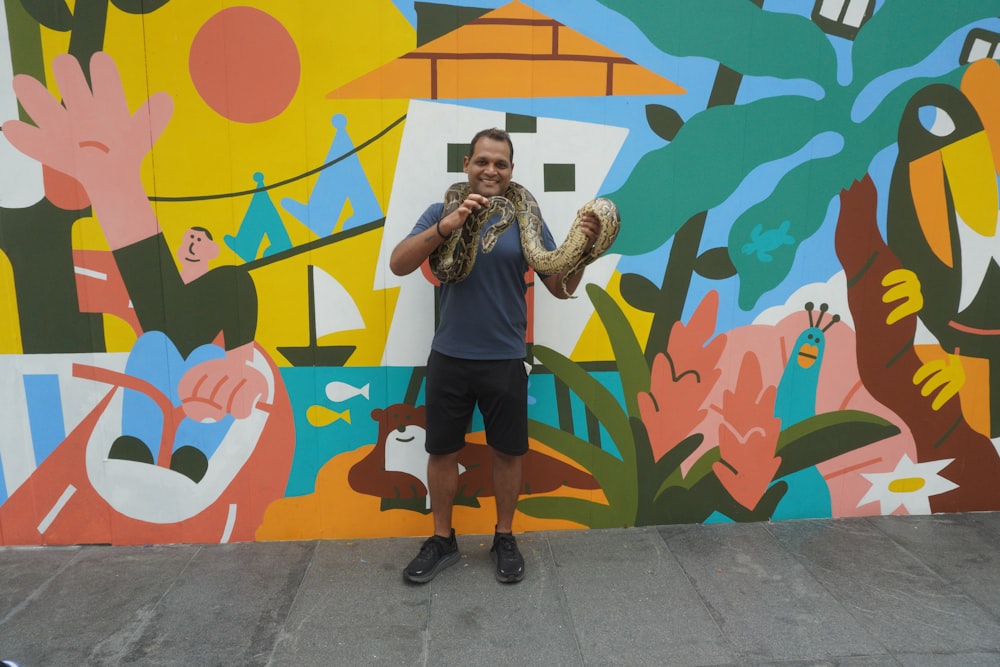 a person standing in front of a wall with graffiti