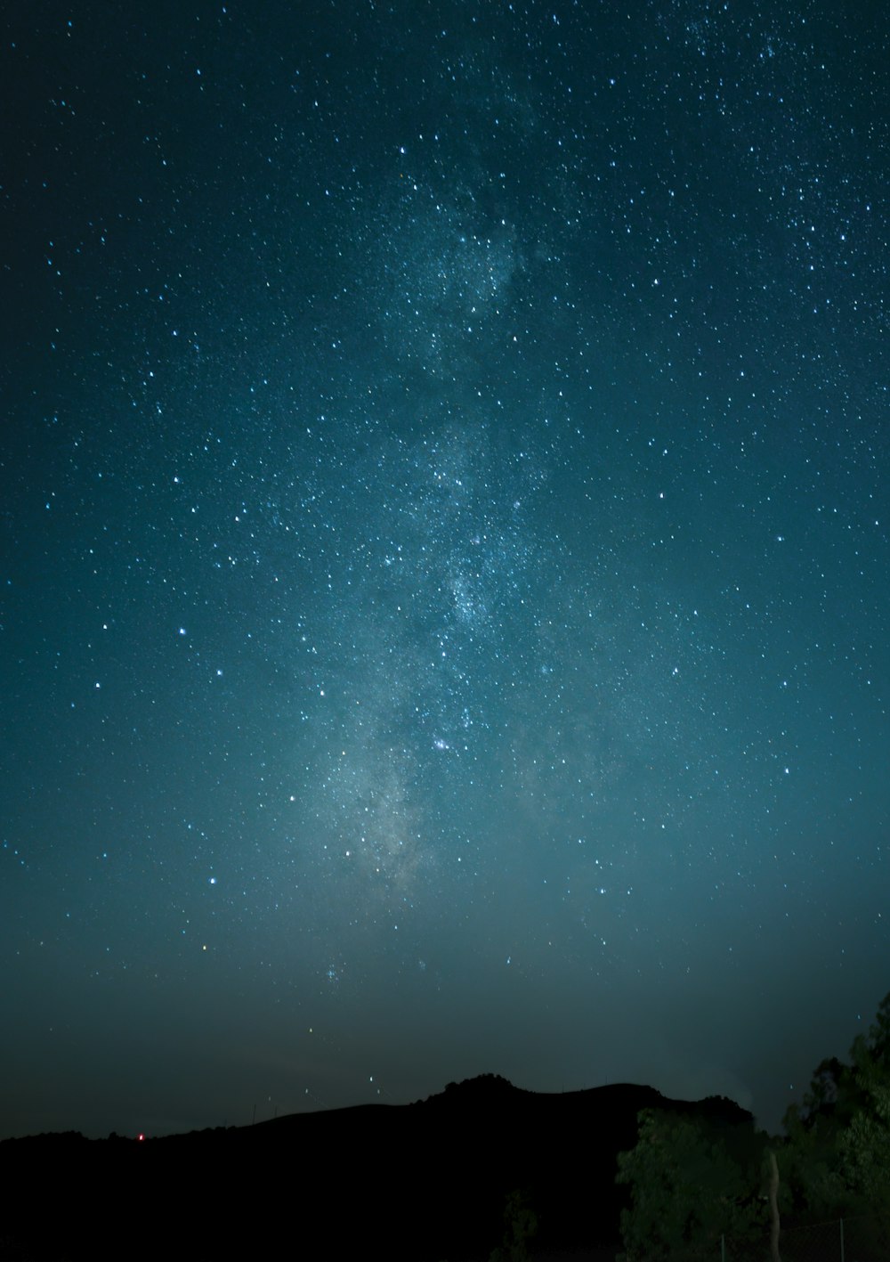 a starry night sky over a mountain range