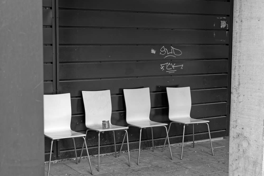 a group of chairs in front of a black door