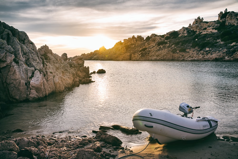 a boat on the shore of a lake