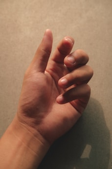 a person's hand with a thumb up