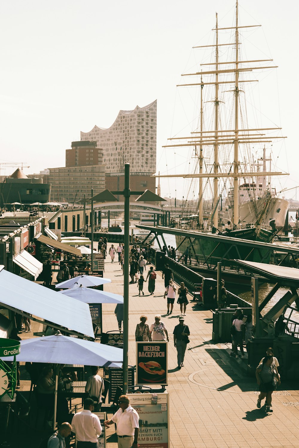 a large sailboat docked at a pier