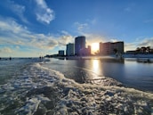 a beach with buildings in the background