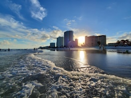 a beach with buildings in the background