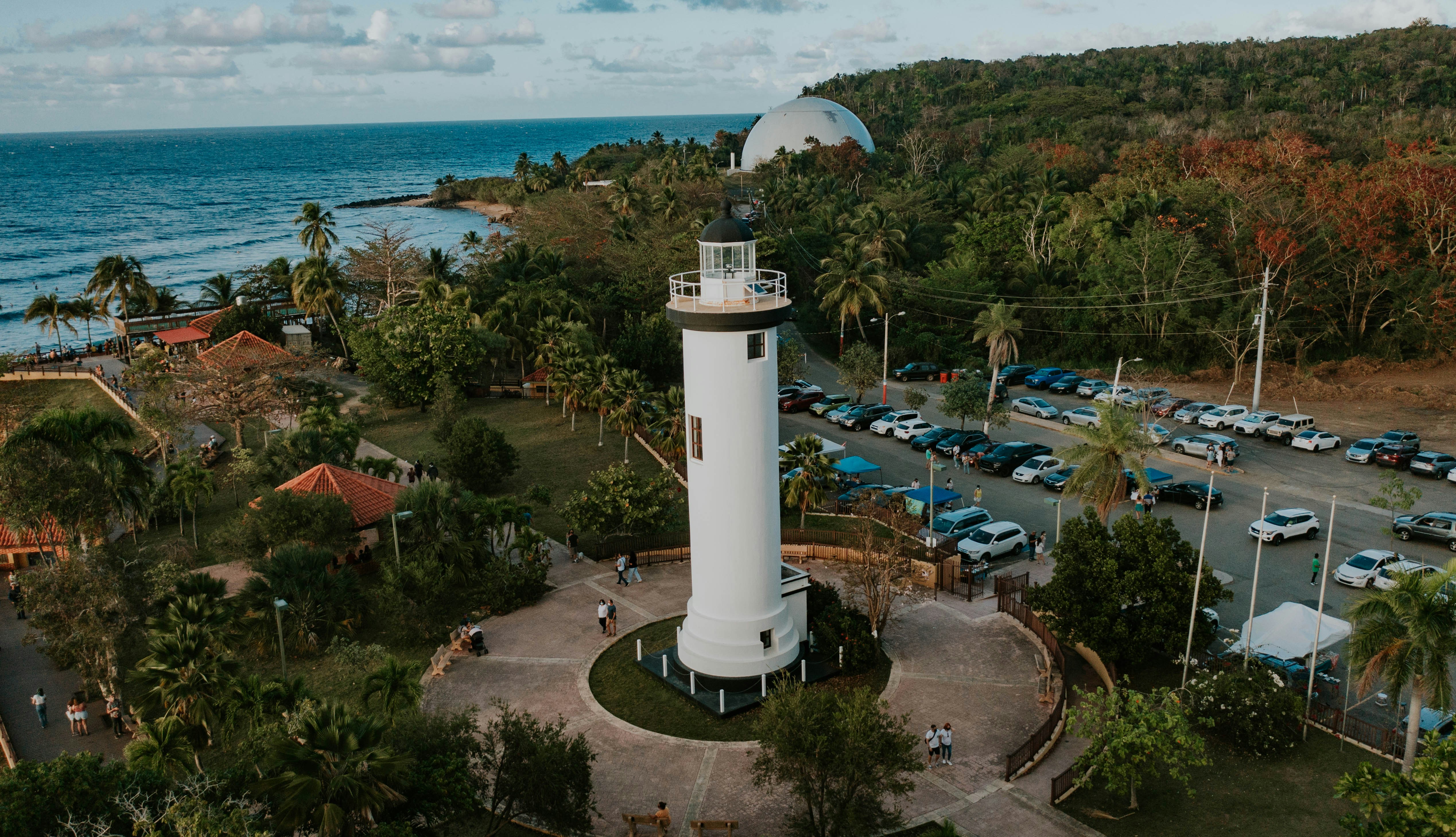 a white tower near a beach, Faro de Rincón en Puerto Rico
