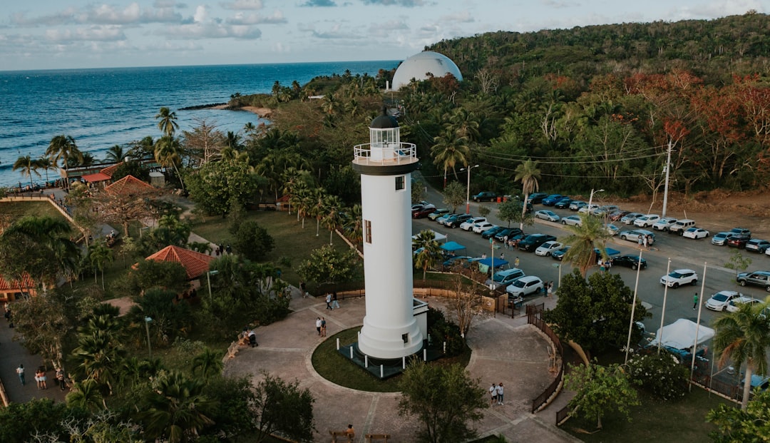 a white tower near a beach, Faro de Rincón en Puerto Rico