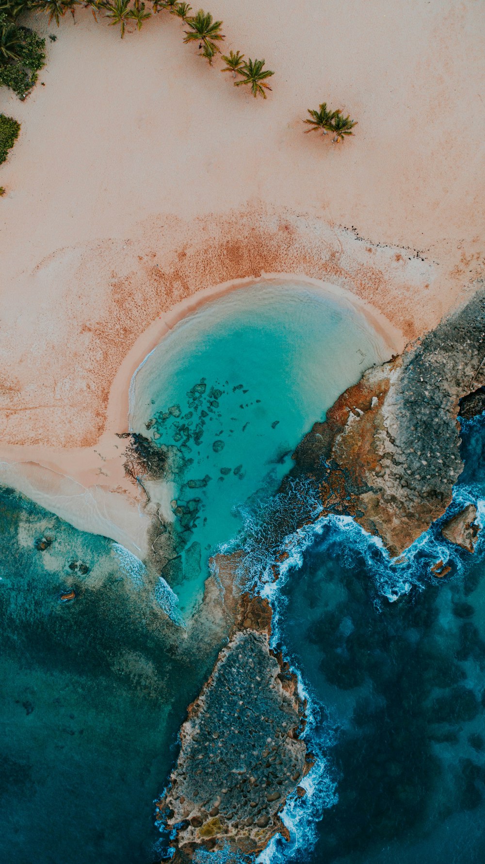 a body of water with a large rock in the middle