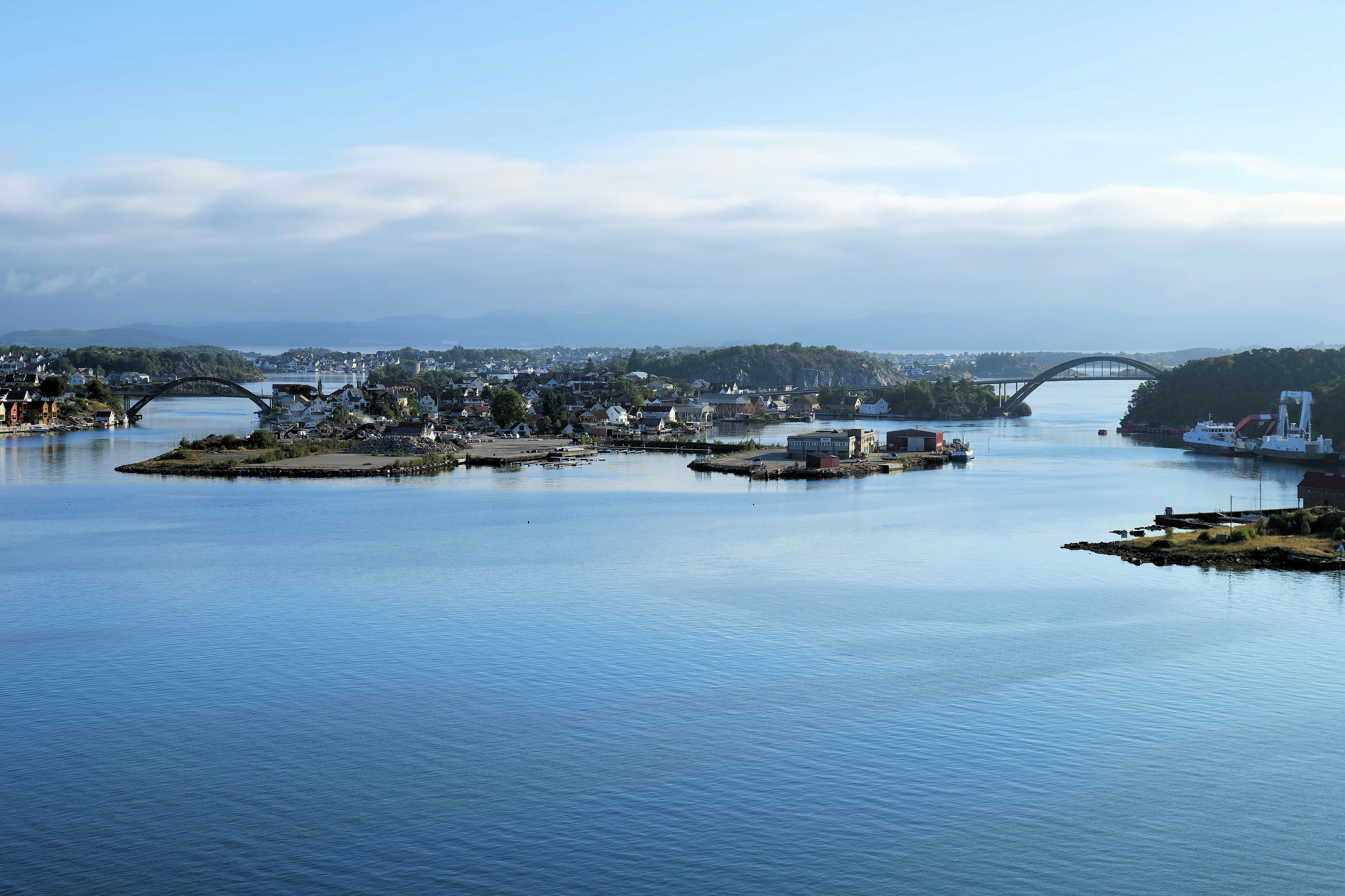 a body of water with buildings and trees around it