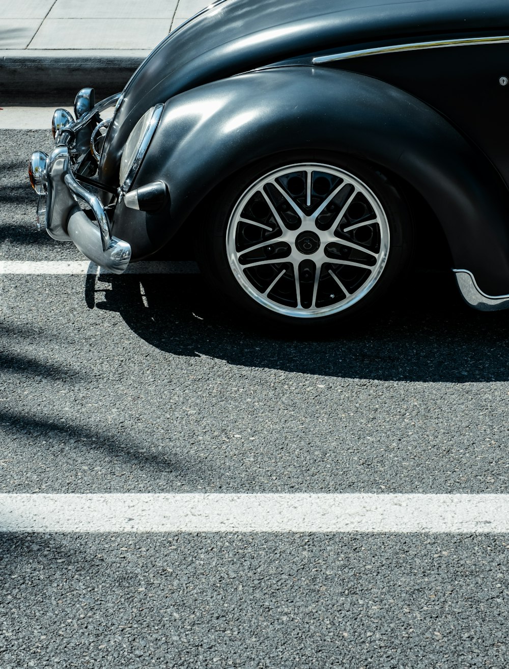 a black car parked on the side of a road