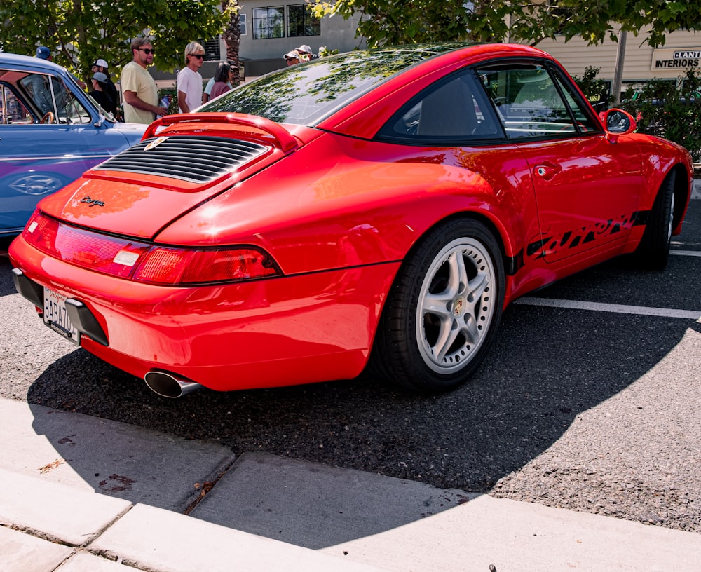 a red car parked on the side of a road