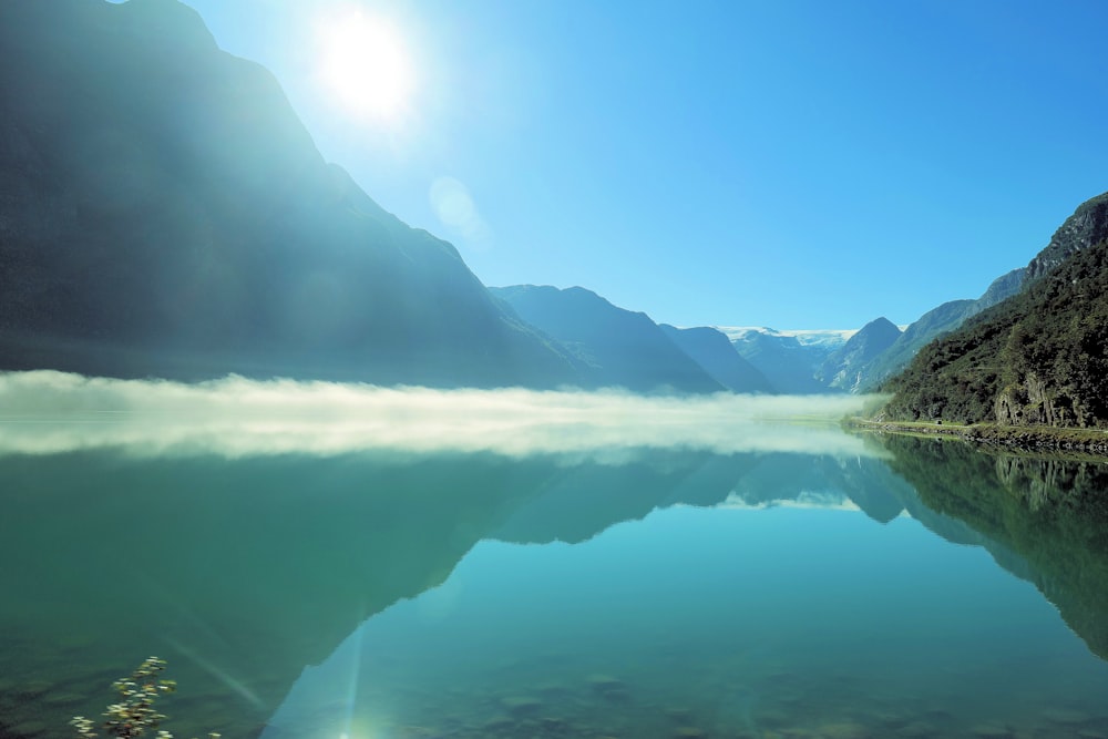 a body of water with mountains in the background