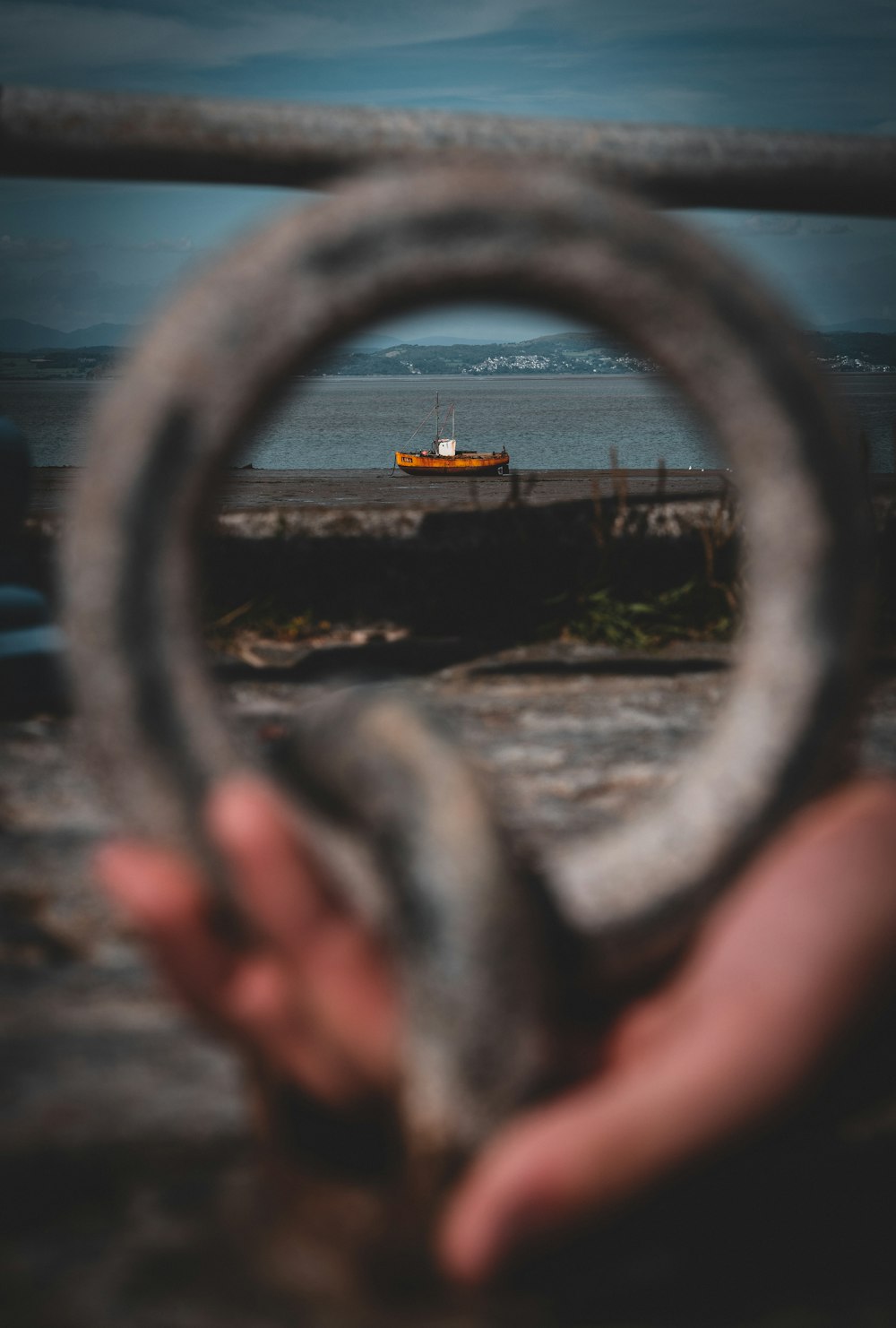 a hand holding a steering wheel