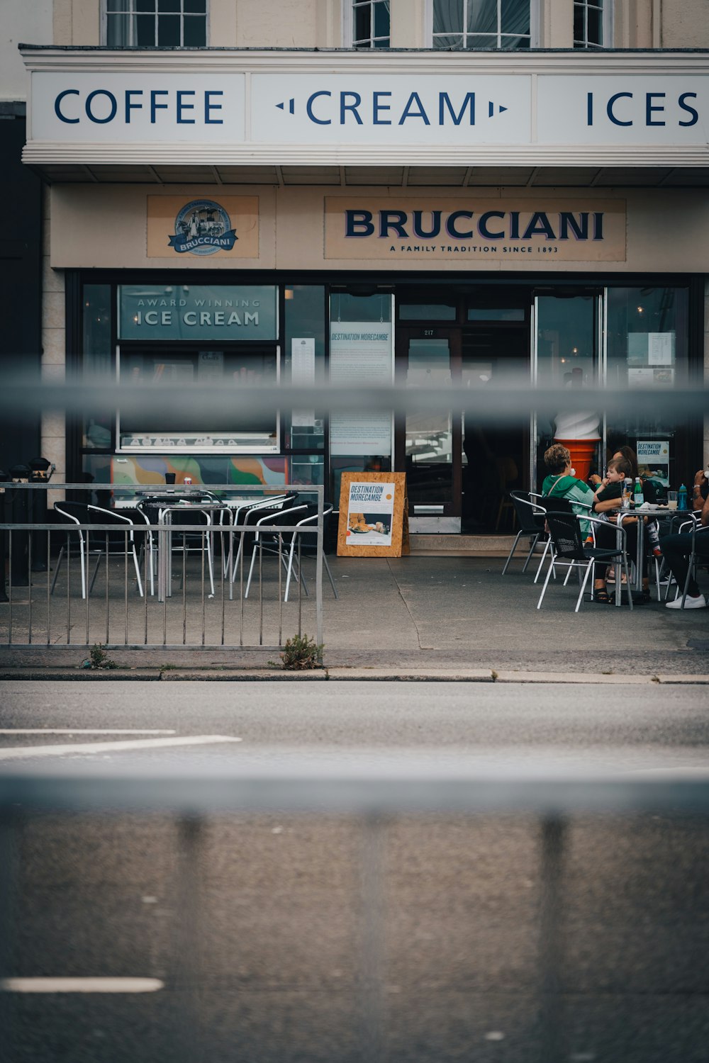 a restaurant with people sitting outside