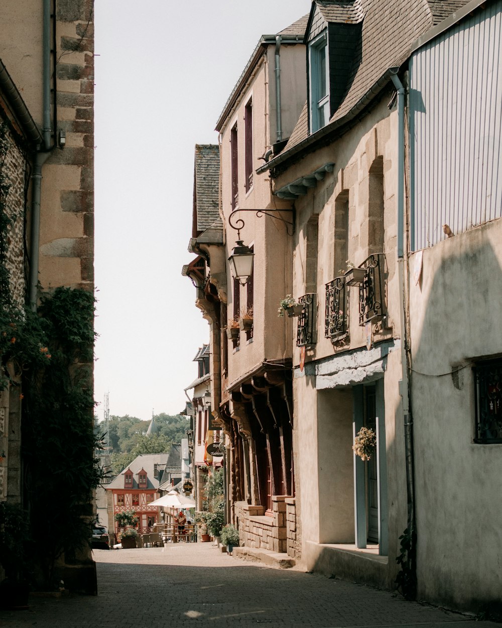 a narrow street in front of a brick building