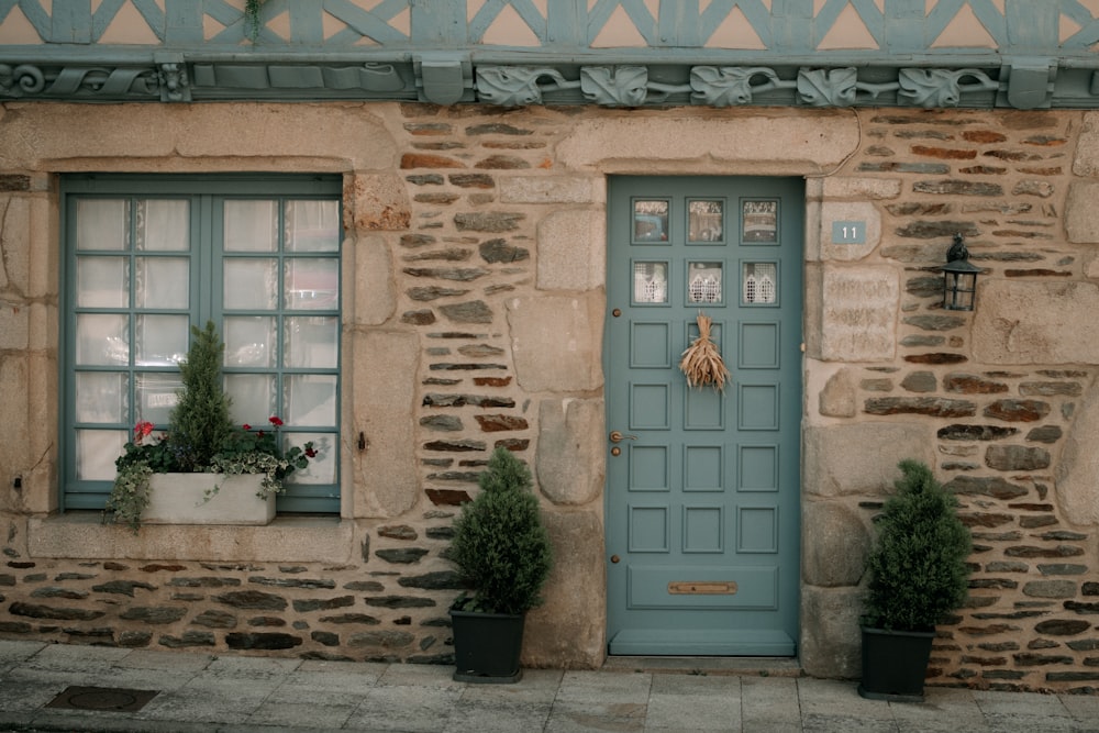 a close up of a stone building that has a green door