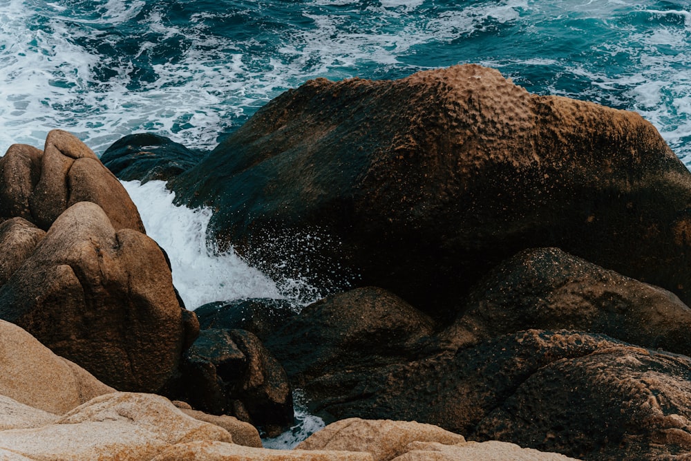 a group of rocks by the water