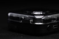 Close-up of advanced medtech device prototype with glowing indicators.