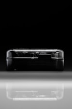 Close-up of a sleek, black device emitting a faint pulse, symbolizing hidden infrastructure.