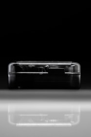 Close-up of a sleek, black device emitting a faint pulse, symbolizing hidden infrastructure.