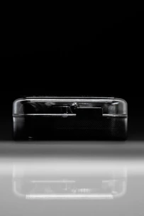 A modern black box with silver accents resting on a polished surface, embodying research essentials.