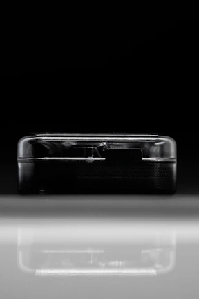 Sleek dark-themed futuristic gadget with glowing blue accents on a black background