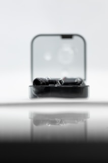Transparent glass-like device case showing intricate hardware components blurred softly in the background