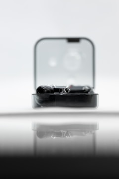 A sleek modern gadget displayed on a wooden table.