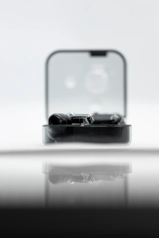 Close-up of a sleek, animated gadget glowing softly on a wooden shelf.
