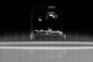 Polished bearing hinges displayed against a dark metallic background.